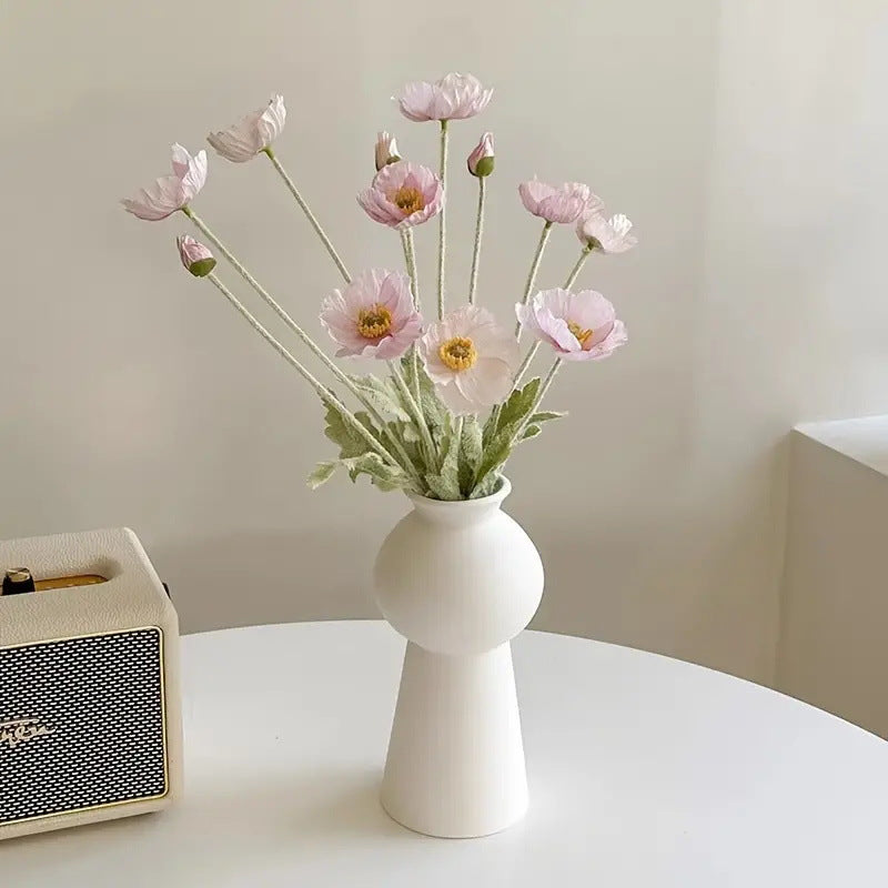 realistic artificial pink poppy flowers arrangement in a modern white ceramic vase for chic bedroom decor