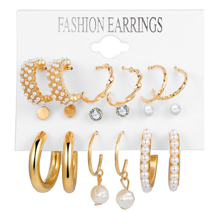 gold chunk hoop pearl earrings set with diverse trendy designs arranged on a clean white background