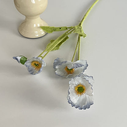 realistic faux silk poppy flowers in light blue gradient color on an aesthetic grey background