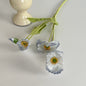 realistic faux silk poppy flowers in light blue gradient color on an aesthetic grey background