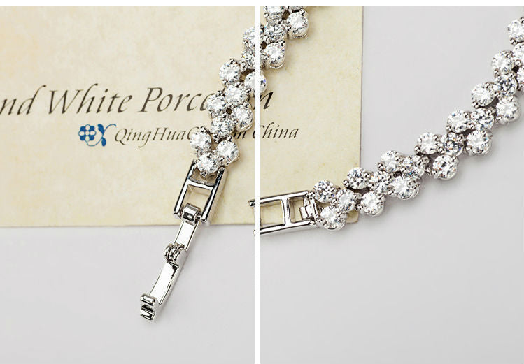 detailed view of the secure fold over clasp closure and micro paved crystal wave chain links