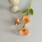 realistic faux silk poppy flowers in soft vibrant coral pink on an aesthetic grey background