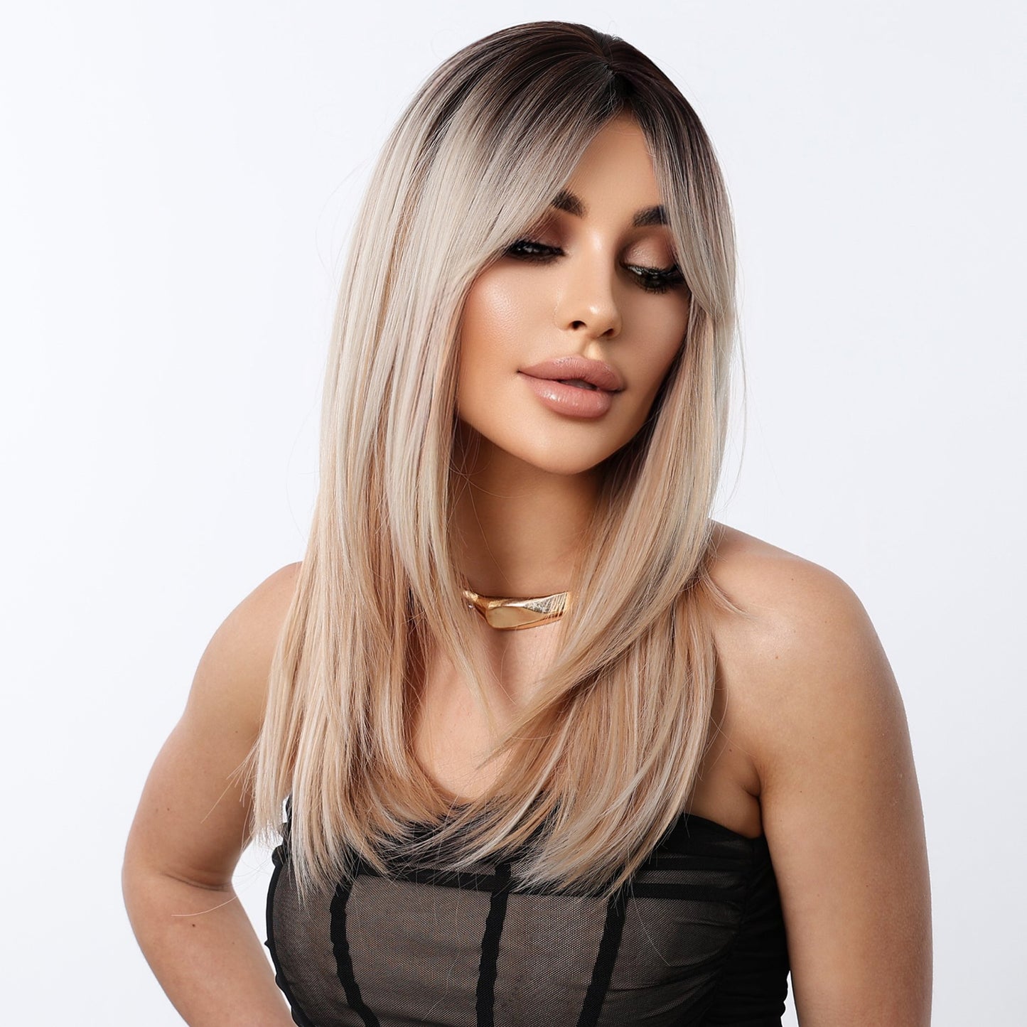 front view of the long straight ash blonde ombre synthetic wig with bangs worn by a model