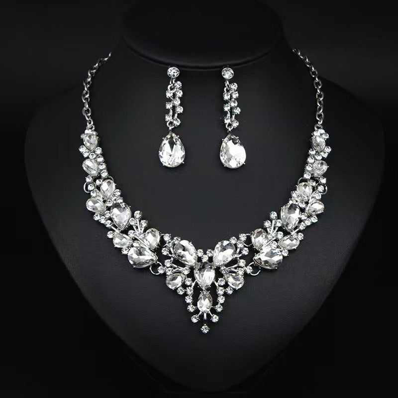elegant waterdrop crystal bridal jewelry set in classic silver color displayed on a black neck mannequin bust