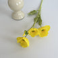 realistic faux silk poppy flowers in bright yellow color on an aesthetic grey background