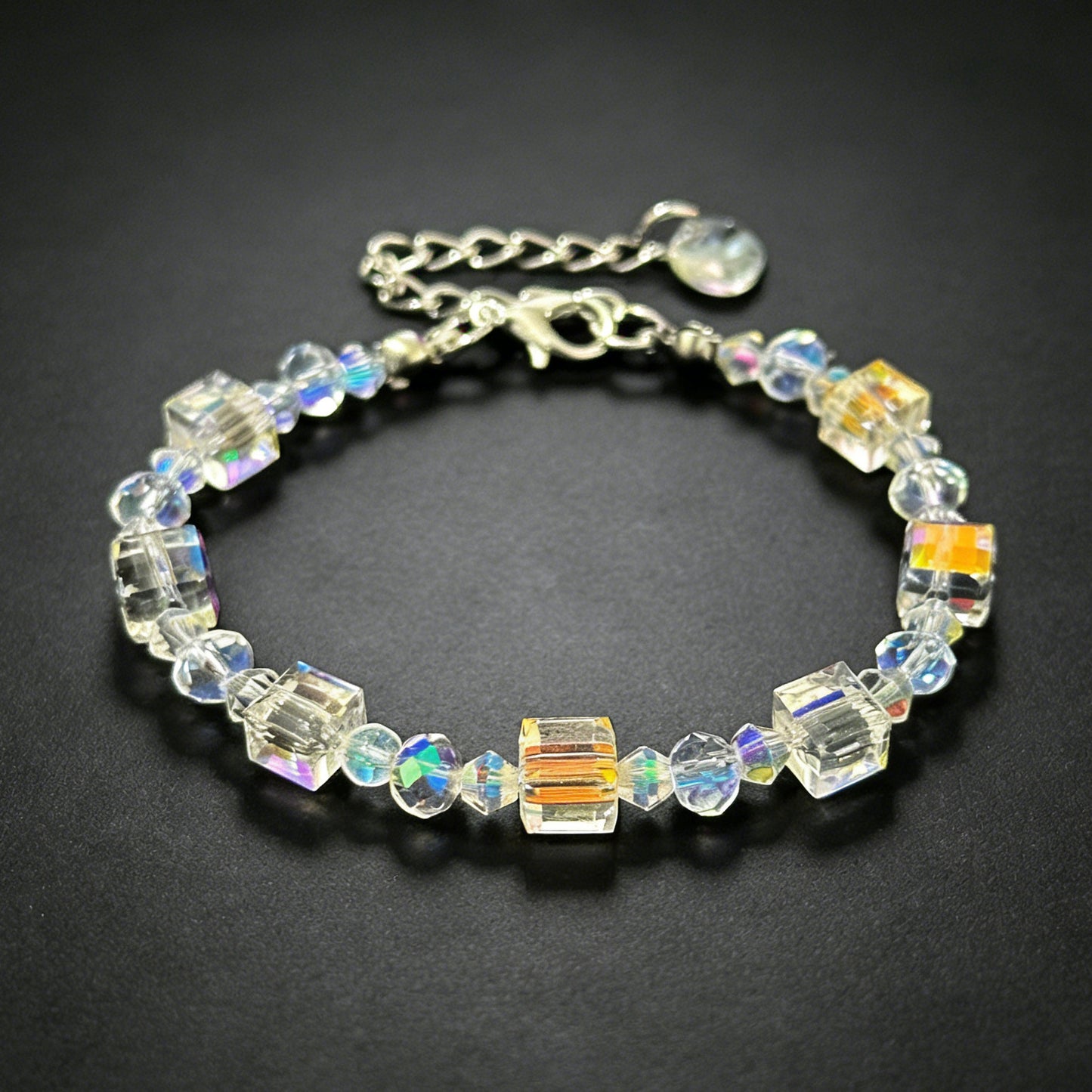 bohemian champagne gold cube crystal bead bracelet with silver adjustable chain on a clean dark background