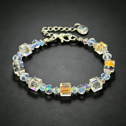 bohemian champagne gold cube crystal bead bracelet with silver adjustable chain on a clean dark background