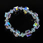 bohemian multicolor cube crystal bead bracelet arranged in a circle on a reflective black background
