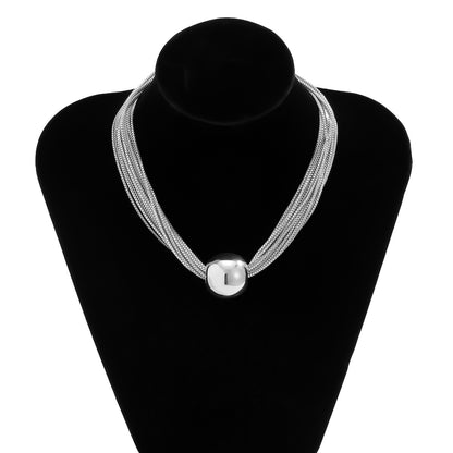 elegant minimalist multi strand layered chain necklace with metal beads on a clean background