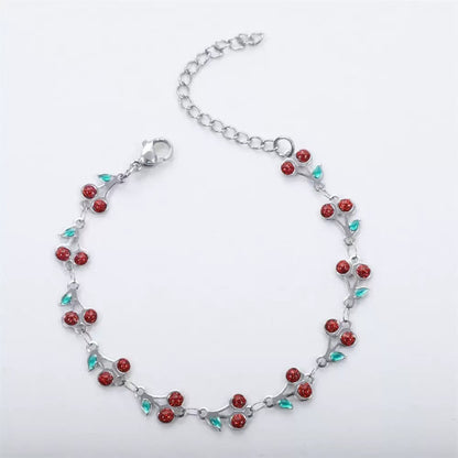 dainty sweet cherry charm link bracelet with playful shimmering summer wristwear design