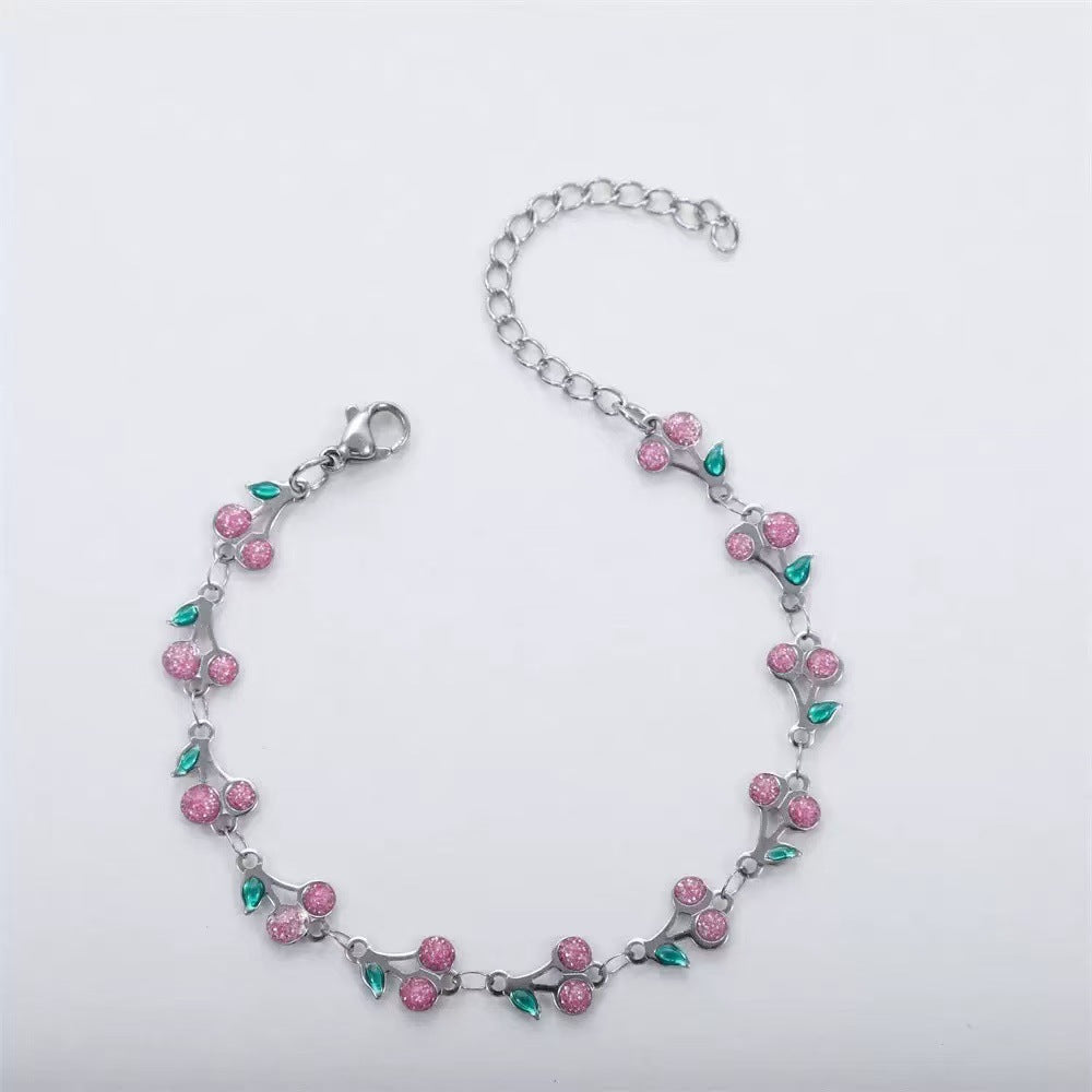 dainty sweet cherry charm link bracelet with playful shimmering summer wristwear design