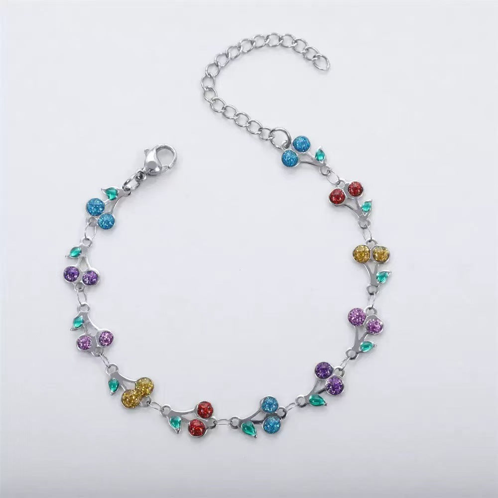 dainty sweet cherry charm link bracelet with playful shimmering summer wristwear design