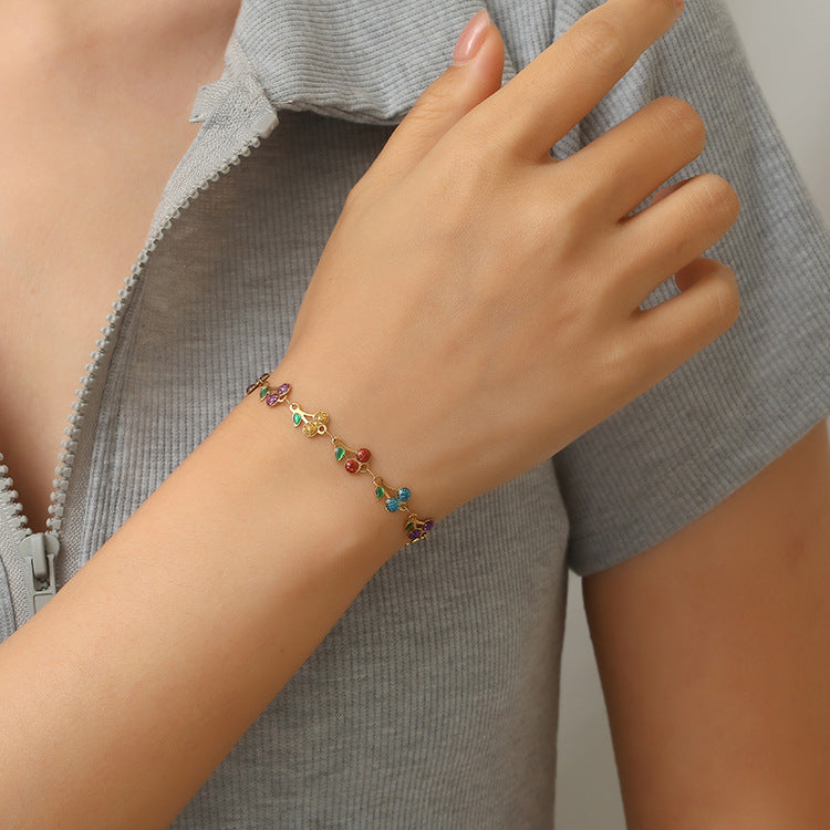 dainty sweet cherry charm link bracelet with playful shimmering summer wristwear design