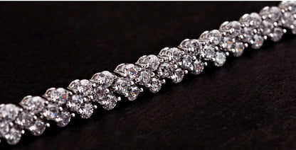detailed close up of iced out sparkling crystal stones on the luxury wave tennis bracelet displaying micro pave craftsmanship