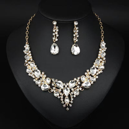 elegant waterdrop crystal bridal jewelry set in luxury gold color displayed on a black neck mannequin bust