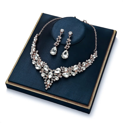 elegant waterdrop crystal bridal jewelry set in luxury gold color displayed on a premium dark blue velvet gift box