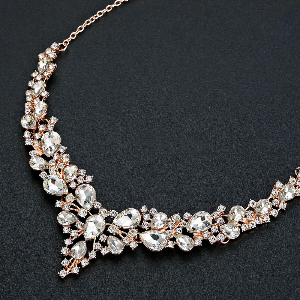 elegant waterdrop crystal bridal jewelry set in rose gold color showcasing a close up view of the rhinestone necklace