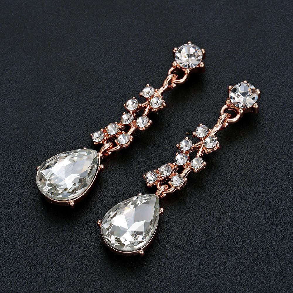 elegant waterdrop crystal bridal jewelry set in rose gold showcasing a detailed view of the matching fluid drop earrings