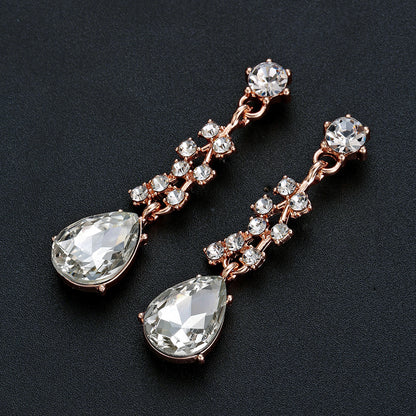elegant waterdrop crystal bridal jewelry set in rose gold showcasing a detailed view of the matching fluid drop earrings