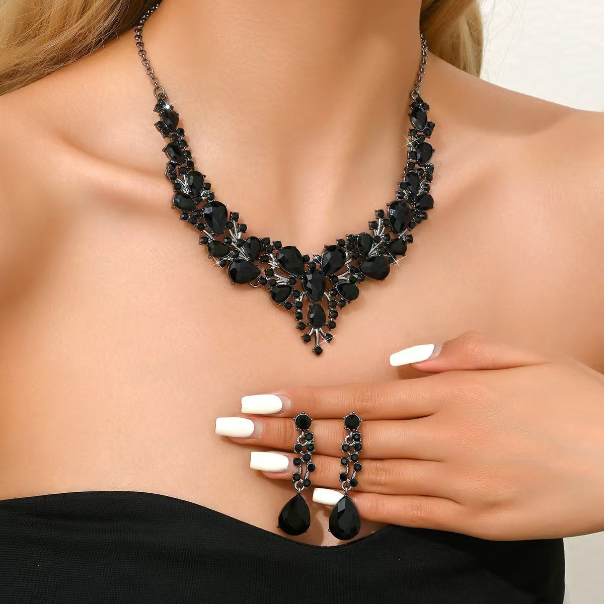elegant waterdrop crystal bridal jewelry set in sleek black color showcasing the statement statement necklace and matching earrings on a model