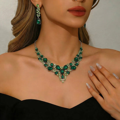 elegant waterdrop crystal bridal jewelry set in vibrant emerald green color with luxury statement necklace and matching drop earrings on a model