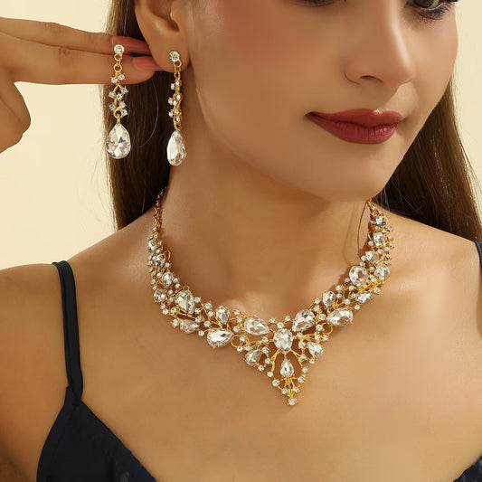 elegant waterdrop crystal bridal jewelry set with luxury statement rhinestone pendant necklace and matching drop earrings worn by a model