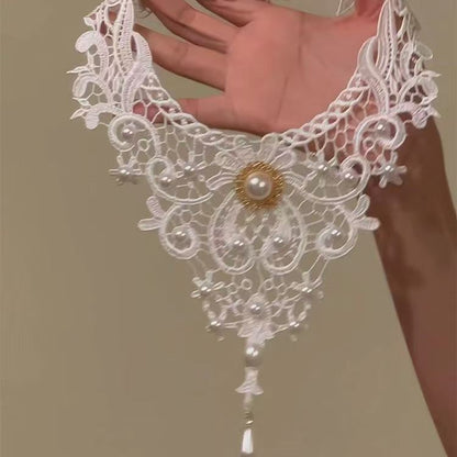 elegant white lace choker necklace with vintage pearl accents and cascading drop pendant details held by a model