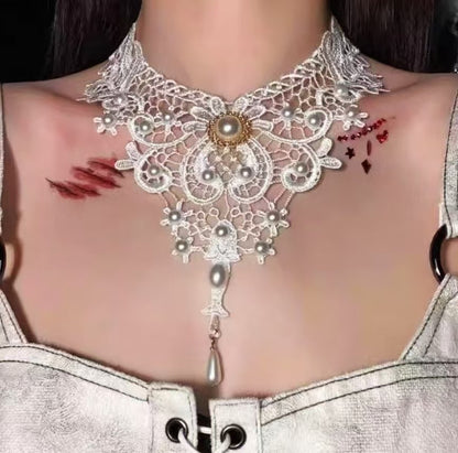 elegant white lace choker necklace with vintage pearl elements and long drop pendant worn by a model
