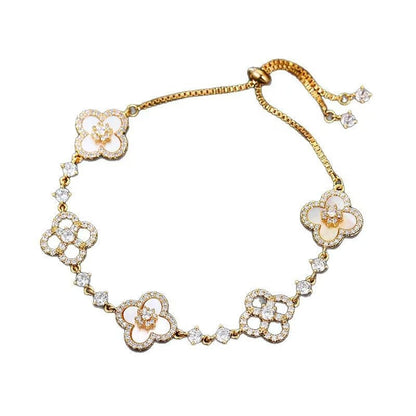 four leaf clover mother of pearl bracelet in champagne gold color with adjustable drawstring chain on a clean white background