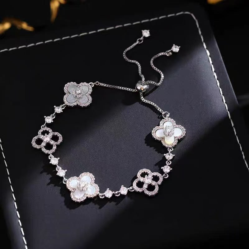 four leaf clover mother of pearl bracelet in classic white color with silver adjustable chain showcasing luxury crystal pave details