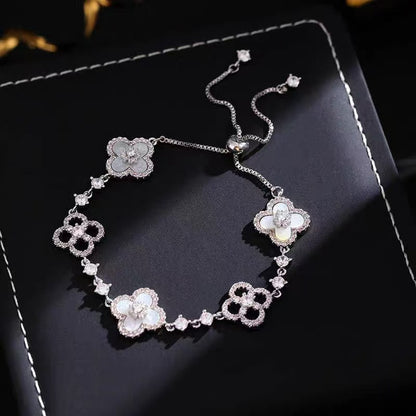 four leaf clover mother of pearl bracelet in classic white color with silver adjustable chain showcasing luxury crystal pave details