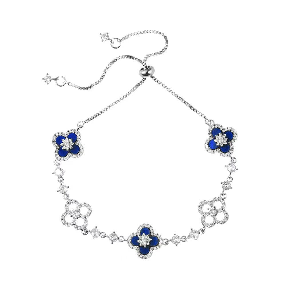 four leaf clover mother of pearl bracelet in royal blue color with silver adjustable chain on a clean white background