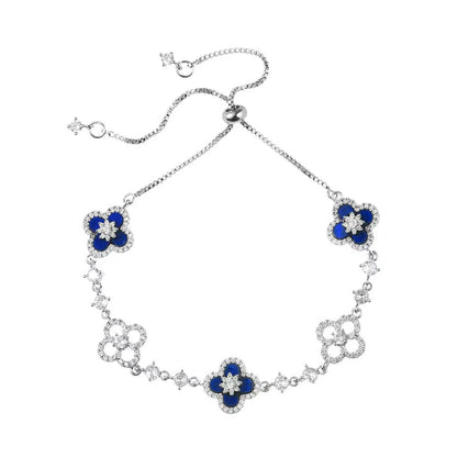 four leaf clover mother of pearl bracelet in royal blue color with silver adjustable chain on a clean white background