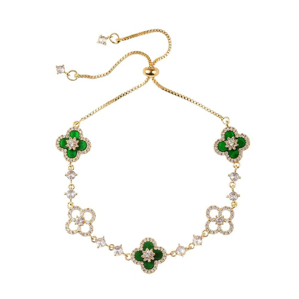 four leaf clover mother of pearl bracelet in vibrant emerald green color with gold adjustable chain on a clean white background