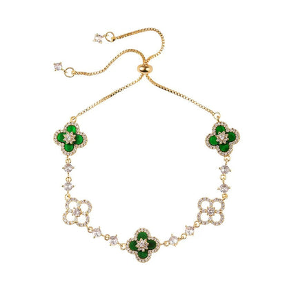 four leaf clover mother of pearl bracelet in vibrant emerald green color with gold adjustable chain on a clean white background
