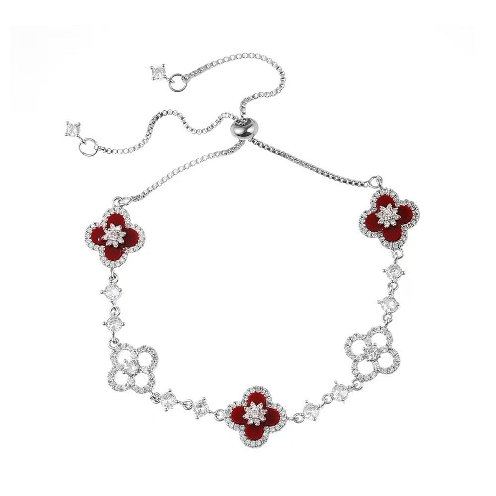 four leaf clover mother of pearl bracelet in vibrant red color with silver adjustable chain on a clean white background