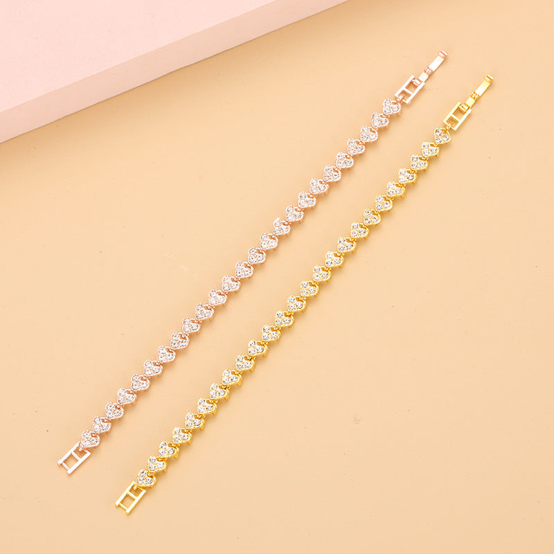 gold and silver heart shape tennis bracelets fully paved with glittering crystals aligned on an elegant background