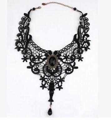 gothic black lace choker necklace with vintage black rhinestone accents and teardrop shape crystal pendant on a white background
