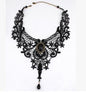 gothic black lace choker necklace with vintage black rhinestone accents and teardrop shape crystal pendant on a white background