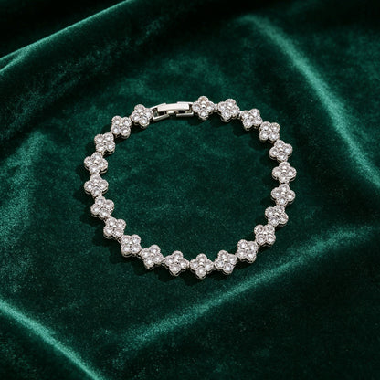 luxury four leaf clover crystal charm bracelet in shiny silver finish on dark green velvet fabric