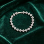 luxury four leaf clover crystal charm bracelet in shiny silver finish on dark green velvet fabric
