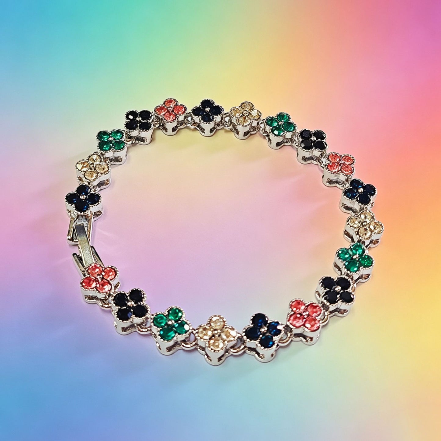 luxury four leaf clover crystal charm bracelet with multicolored iced out rhinestone gems on a vibrant gradient background