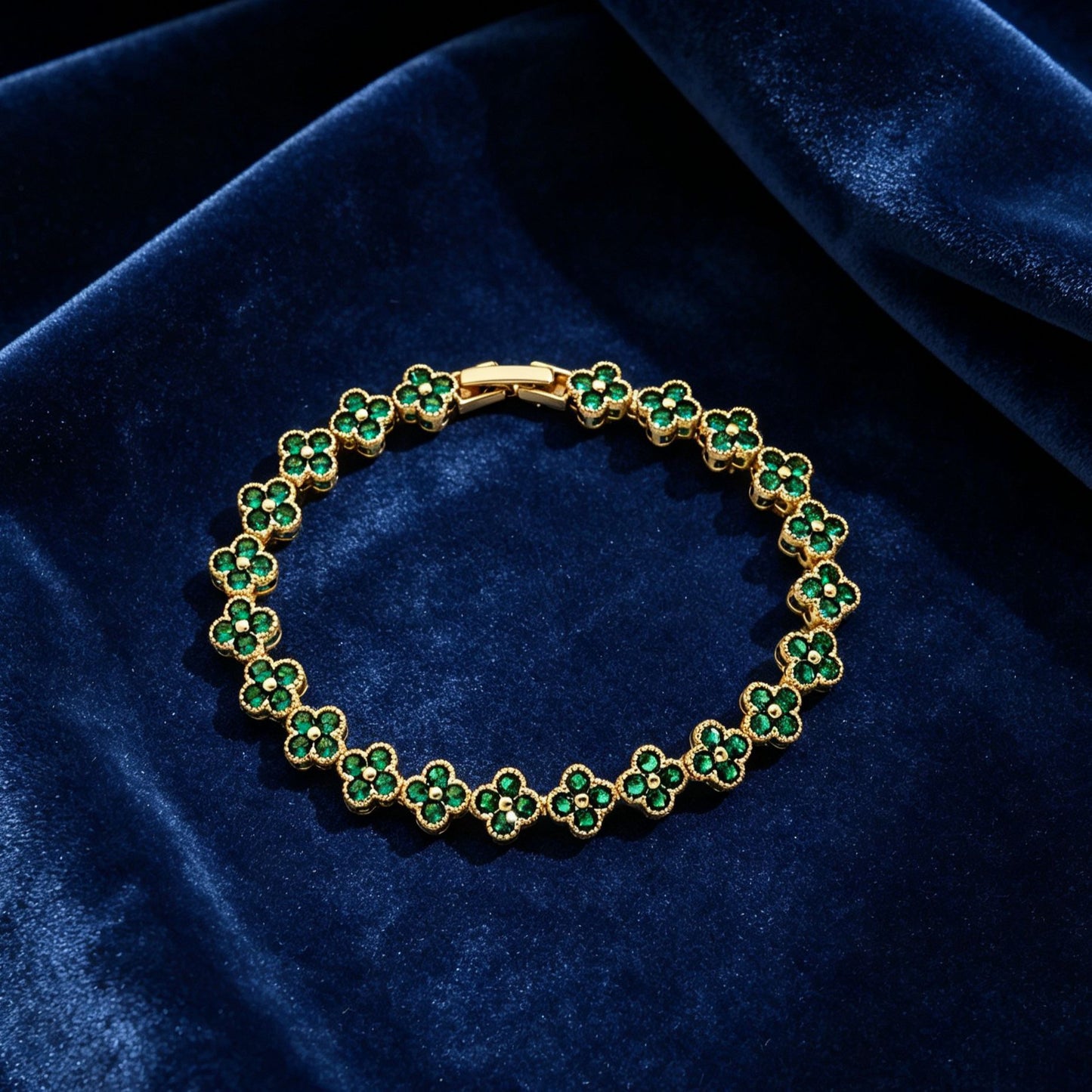luxury four leaf clover crystal charm bracelet with vibrant emerald green rhinestone gems on dark blue velvet