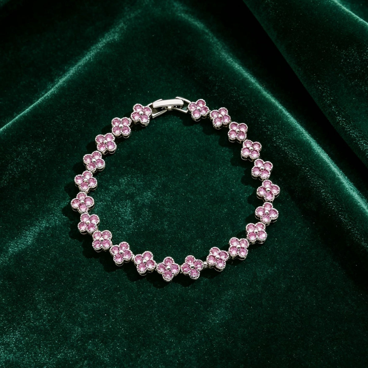 luxury four leaf clover rhinestone charm bracelet in silver with vibrant pink crystals on green velvet