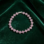 luxury four leaf clover rhinestone charm bracelet in silver with vibrant pink crystals on green velvet